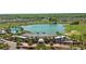 Aerial view of community center with pool, golf course, and lake at 4747 Nw 35Th Lane Rd, Ocala, FL 34482