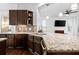 Modern kitchen with granite countertops, dark wood cabinets, and island at 4747 Nw 35Th Lane Rd, Ocala, FL 34482