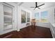 Bright sunroom/office with rocking chair and backyard view at 4747 Nw 35Th Lane Rd, Ocala, FL 34482