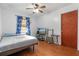 Bedroom with wood floors, ceiling fan, and a double bed at 6 Rosalie Oaks Blvd, Lake Wales, FL 33898