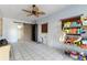 Spacious bonus room with tile floors, ceiling fan, and built-in shelving at 6 Rosalie Oaks Blvd, Lake Wales, FL 33898