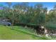 View of a calm canal with lush green vegetation and a small boat dock at 6 Rosalie Oaks Blvd, Lake Wales, FL 33898