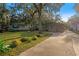 Long driveway leading to a house with a large front yard at 6 Rosalie Oaks Blvd, Lake Wales, FL 33898