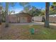 House exterior with a double door entry and a mature landscape at 6 Rosalie Oaks Blvd, Lake Wales, FL 33898
