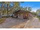 House exterior featuring a brown single story home with red doors and a paved driveway at 6 Rosalie Oaks Blvd, Lake Wales, FL 33898