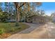 House exterior featuring a brown single story home with red doors and a paved driveway at 6 Rosalie Oaks Blvd, Lake Wales, FL 33898