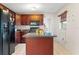 Kitchen features dark wood cabinets, granite countertops, and a large island at 6 Rosalie Oaks Blvd, Lake Wales, FL 33898