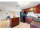 Kitchen with dark wood cabinets, black appliances, and an island at 6 Rosalie Oaks Blvd, Lake Wales, FL 33898