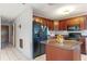 View of kitchen with dark wood cabinets, island, and stainless steel appliances at 6 Rosalie Oaks Blvd, Lake Wales, FL 33898