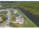 Aerial view of a house nestled in a neighborhood near a waterway, offering a tranquil setting at 6180 Knotty Pine Ct, Port Orange, FL 32127