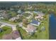 Aerial perspective of houses in a neighborhood near a lake, highlighting waterfront property at 6180 Knotty Pine Ct, Port Orange, FL 32127