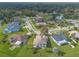 Aerial view showcasing a residential neighborhood with houses and lush green landscape at 6180 Knotty Pine Ct, Port Orange, FL 32127