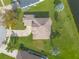 Bird's-eye view of a house, emphasizing its roofline, driveway, and surrounding yard at 6180 Knotty Pine Ct, Port Orange, FL 32127