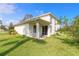 House with covered patio and grassy backyard at 6180 Knotty Pine Ct, Port Orange, FL 32127