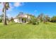 Spacious backyard with lush green grass and mature trees at 6180 Knotty Pine Ct, Port Orange, FL 32127