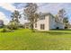 Two-story house, grassy backyard, mature trees at 6180 Knotty Pine Ct, Port Orange, FL 32127