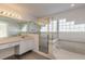 Bathroom with double sinks, shower, and bathtub at 6180 Knotty Pine Ct, Port Orange, FL 32127