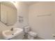 Simple bathroom with pedestal sink and toilet at 6180 Knotty Pine Ct, Port Orange, FL 32127