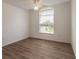 Charming bedroom with wood-look floors and large window at 6180 Knotty Pine Ct, Port Orange, FL 32127