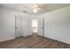 Well-lit bedroom with wood-look floors and access to upper level at 6180 Knotty Pine Ct, Port Orange, FL 32127