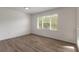Bright bedroom with wood-look floors and large window at 6180 Knotty Pine Ct, Port Orange, FL 32127