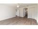 Bright bedroom with wood-look floors and access to bathroom at 6180 Knotty Pine Ct, Port Orange, FL 32127