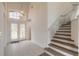 Two-story entryway with tiled floors and staircase at 6180 Knotty Pine Ct, Port Orange, FL 32127