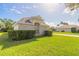 Two-story brick home with a large front yard, driveway, and mature landscaping at 6180 Knotty Pine Ct, Port Orange, FL 32127