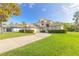 Two-story house with brick facade, lush lawn, and a spacious driveway at 6180 Knotty Pine Ct, Port Orange, FL 32127