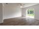 Spacious Gathering room featuring hardwood floors and sliding glass doors leading to the backyard at 6180 Knotty Pine Ct, Port Orange, FL 32127