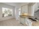 Kitchen features white cabinets, granite countertops and a breakfast nook at 6180 Knotty Pine Ct, Port Orange, FL 32127