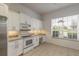 Bright kitchen with white cabinets, granite countertops and stainless steel appliances at 6180 Knotty Pine Ct, Port Orange, FL 32127