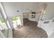 Open concept living area with high ceilings and a view of the kitchen and backyard at 6180 Knotty Pine Ct, Port Orange, FL 32127