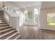 Bright living room with high ceilings, hardwood floors, and abundant natural light at 6180 Knotty Pine Ct, Port Orange, FL 32127