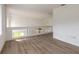 Open loft area with wood-look floors at 6180 Knotty Pine Ct, Port Orange, FL 32127
