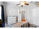 Bright bedroom with ceiling fan, dresser, and crib at 101 Marathon Ln, Sanford, FL 32771