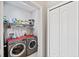 Laundry room with washer, dryer, and storage shelves at 101 Marathon Ln, Sanford, FL 32771