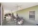Relaxing screened patio with seating area, ceiling fans, and lush landscaping at 101 Marathon Ln, Sanford, FL 32771