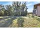 Large backyard with a chain link fence and mature trees at 1185 N Old Mill Dr, Deltona, FL 32725