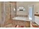 Bathroom boasts a shower, bathtub, and updated tile at 1185 N Old Mill Dr, Deltona, FL 32725