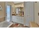 Clean bathroom with a vanity, tub, and linen closet at 1185 N Old Mill Dr, Deltona, FL 32725