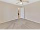 Empty bedroom with ceiling fan and door to hallway at 1185 N Old Mill Dr, Deltona, FL 32725