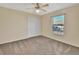 Simple bedroom with ceiling fan and neutral wall colors at 1185 N Old Mill Dr, Deltona, FL 32725