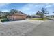 House exterior showcasing a two-car garage and well-manicured lawn at 1185 N Old Mill Dr, Deltona, FL 32725