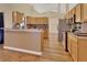 Open kitchen with light wood cabinets and granite countertops at 1185 N Old Mill Dr, Deltona, FL 32725
