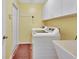 Laundry room with washer, dryer, and ample storage at 1185 N Old Mill Dr, Deltona, FL 32725