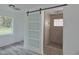 Modern bathroom with barn door and walk-in shower at 1518 Lakeside Dr, Deland, FL 32720