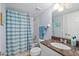 Updated bathroom with granite countertop, shower/tub combo, and striped shower curtain at 3311 S Atlantic Ave # 304, Daytona Beach Shores, FL 32118