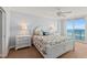 Main bedroom with ocean view and white bed frame at 3311 S Atlantic Ave # 304, Daytona Beach Shores, FL 32118