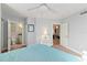 Spacious bedroom with a white bed frame, teal bedding and access to a bathroom and hallway at 3311 S Atlantic Ave # 304, Daytona Beach Shores, FL 32118